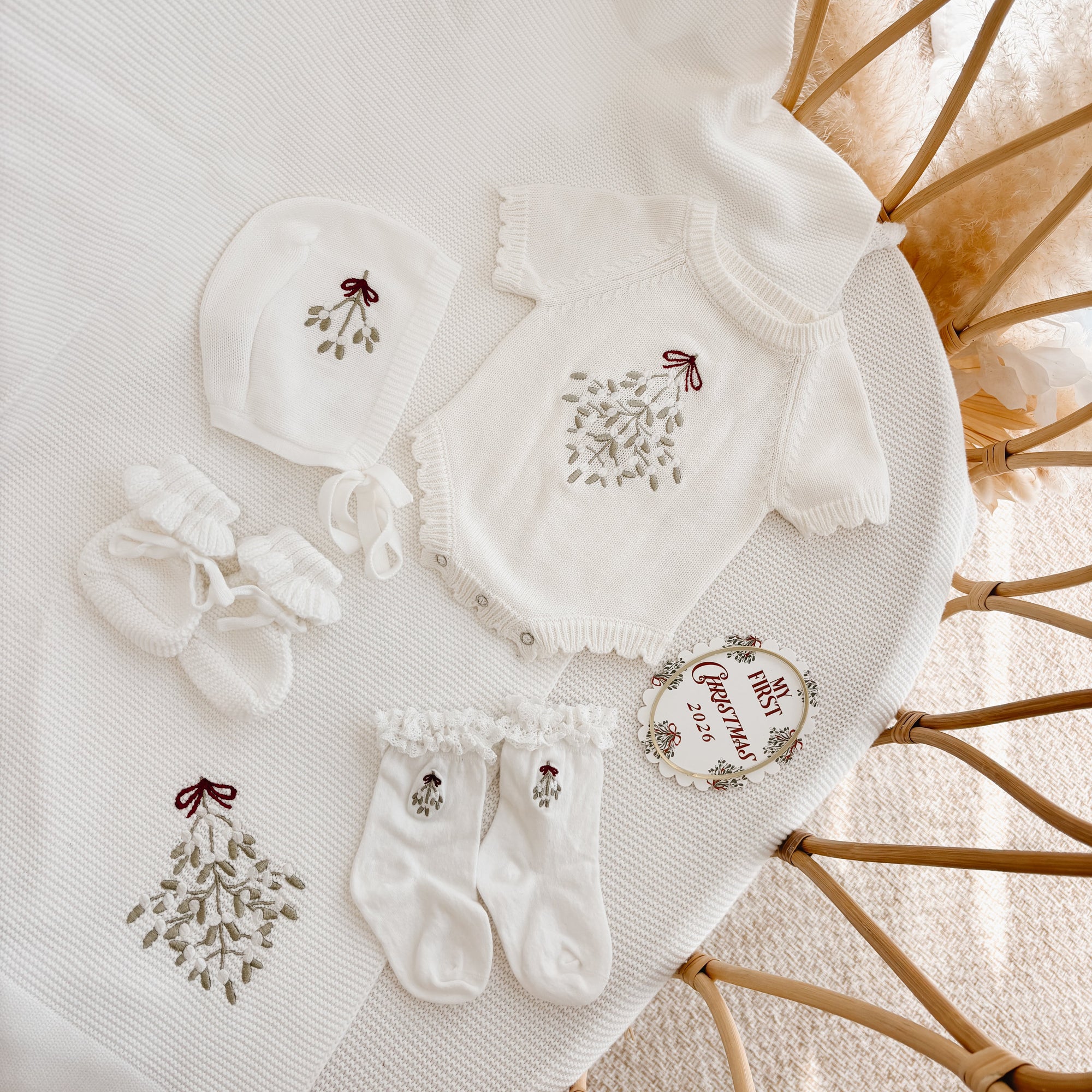 Mistletoe embroidered knit baby romper with matching bonnet, booties, frill socks and My First Christmas disc
