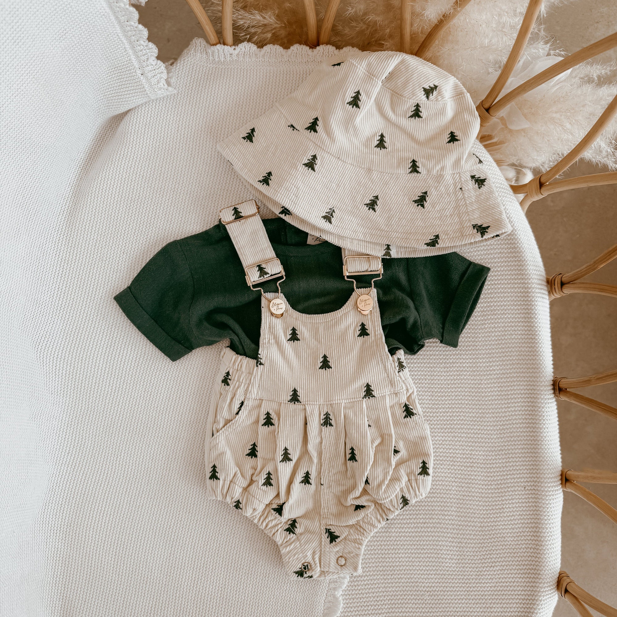 Cream corduroy baby overall romper with a green Christmas tree print, matching bucket hat and forest green tee