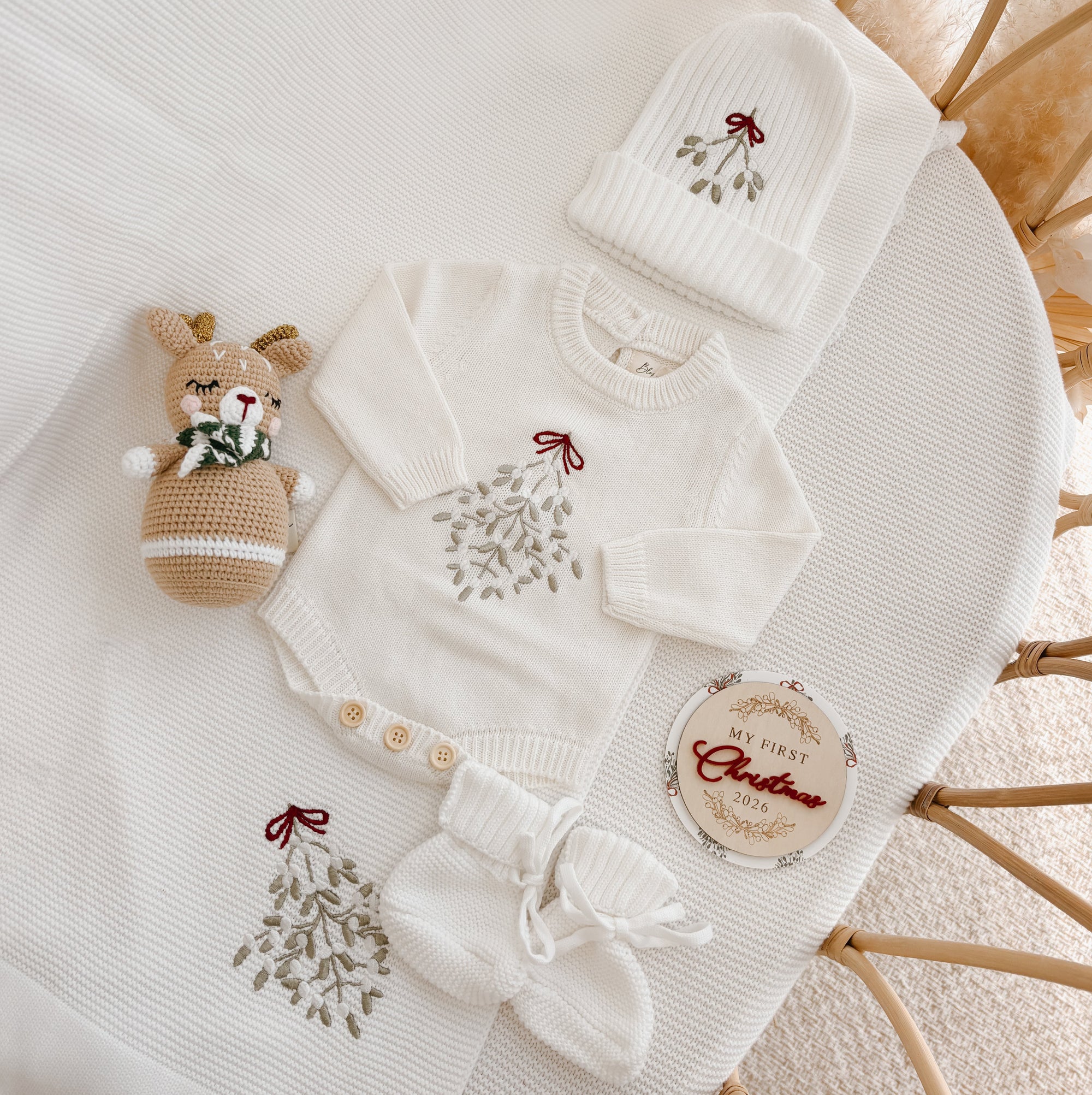 Mistletoe embroidered knit baby jumper, beanie, booties and My First Christmas 2026 disc with a crochet reindeer rattle