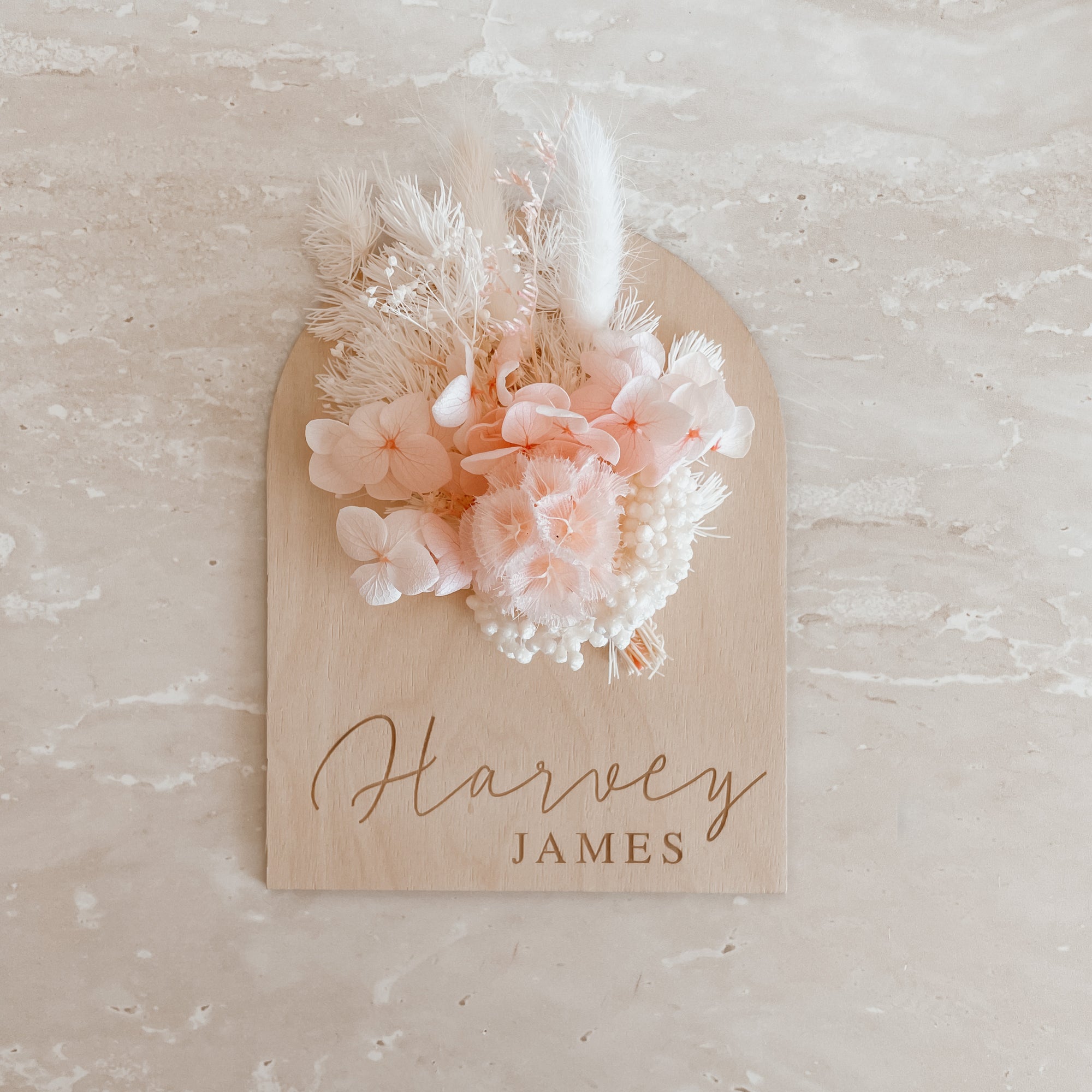 Personalised wooden baby name arch plaque engraved with name and includes pink blush dried florals