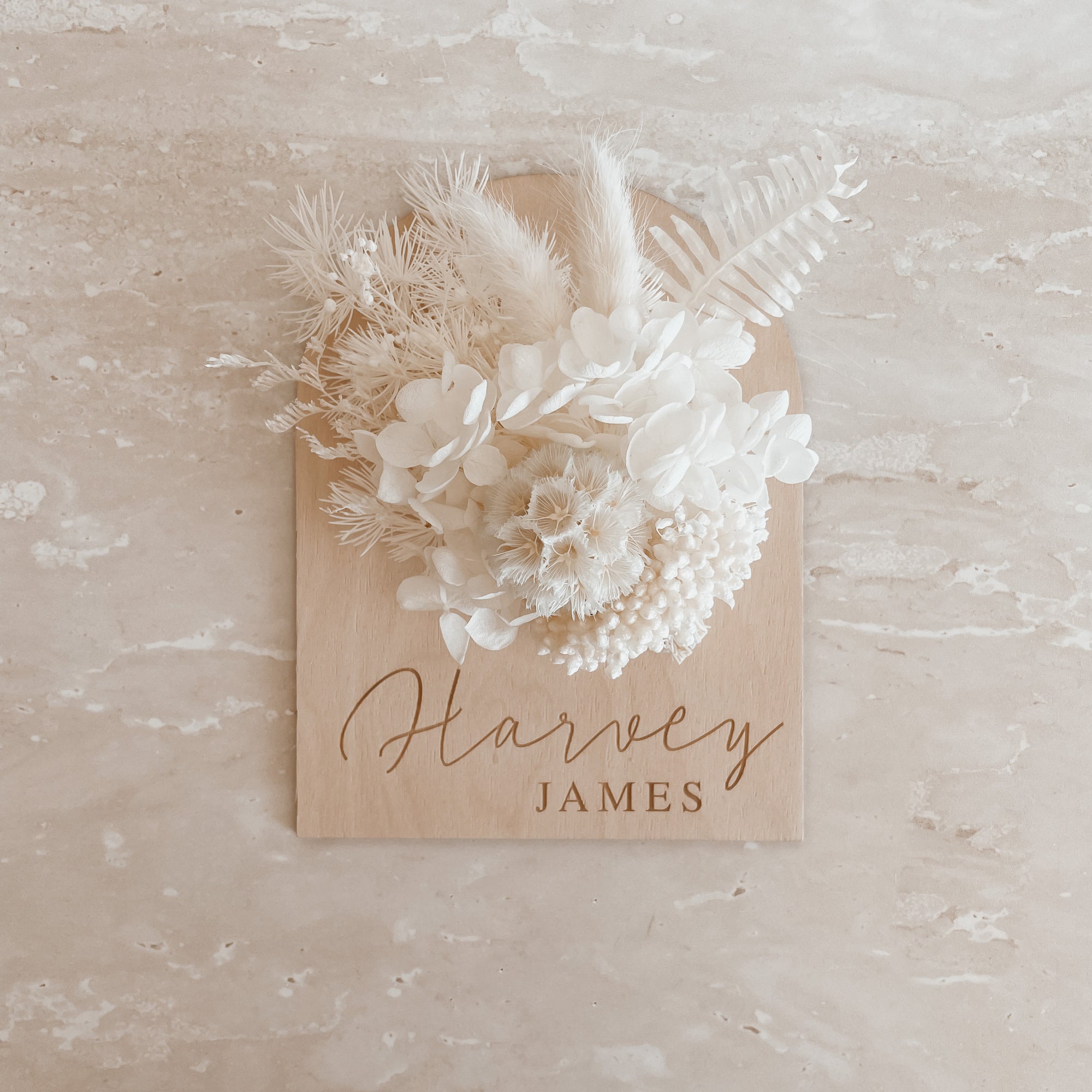 Personalised wooden baby name arch plaque engraved with name and includes white dried florals