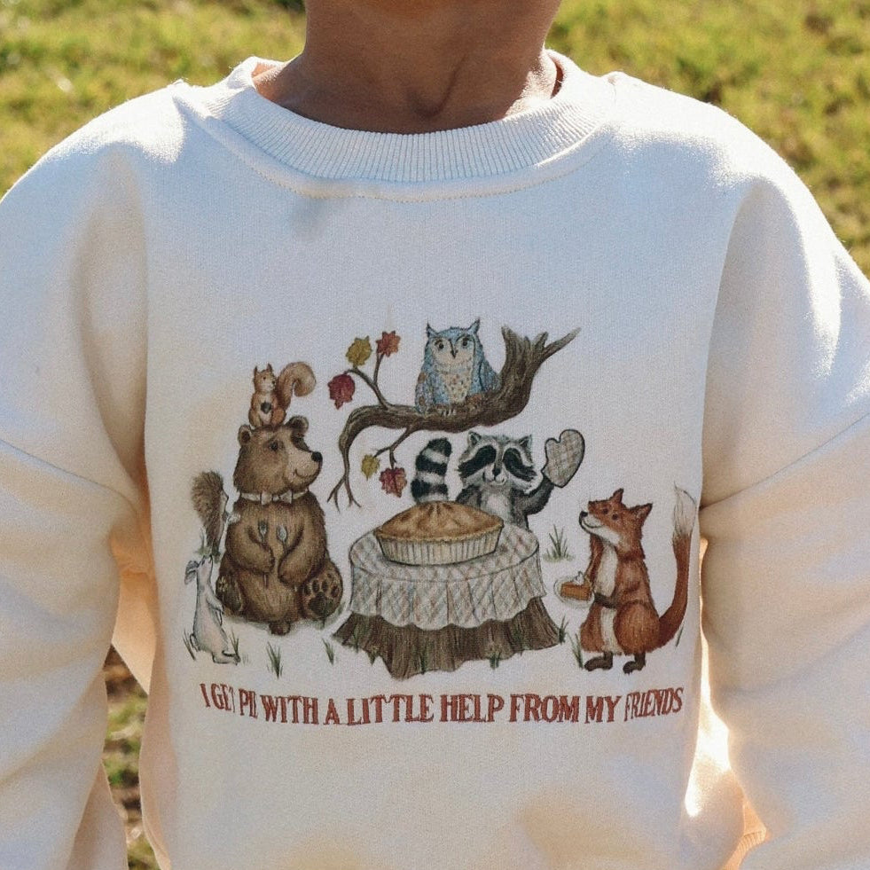 Close up of a cream kids sweatshirt printed with woodland animals and I Get Pie With A Little Help From My Friends